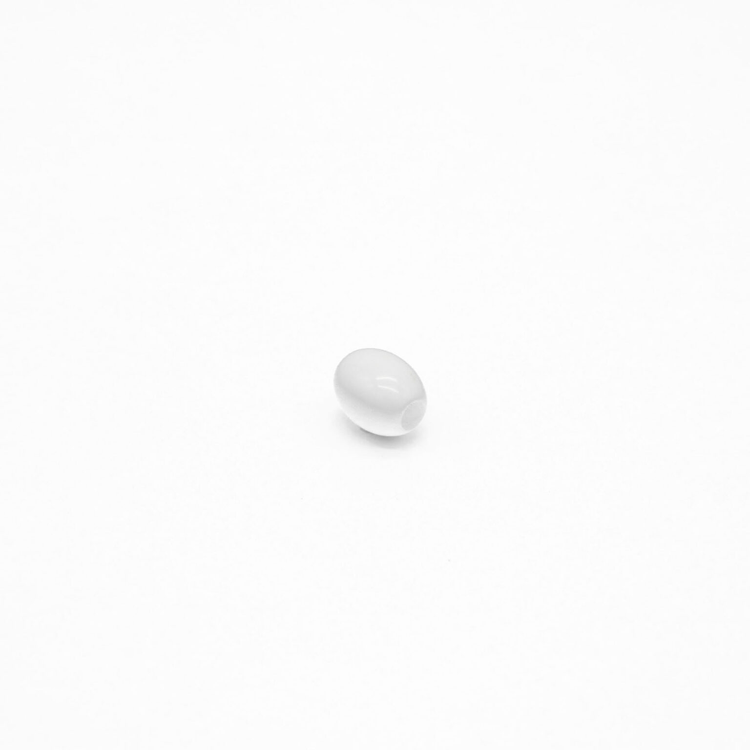 This is a bead, made from plastic and White in colour.