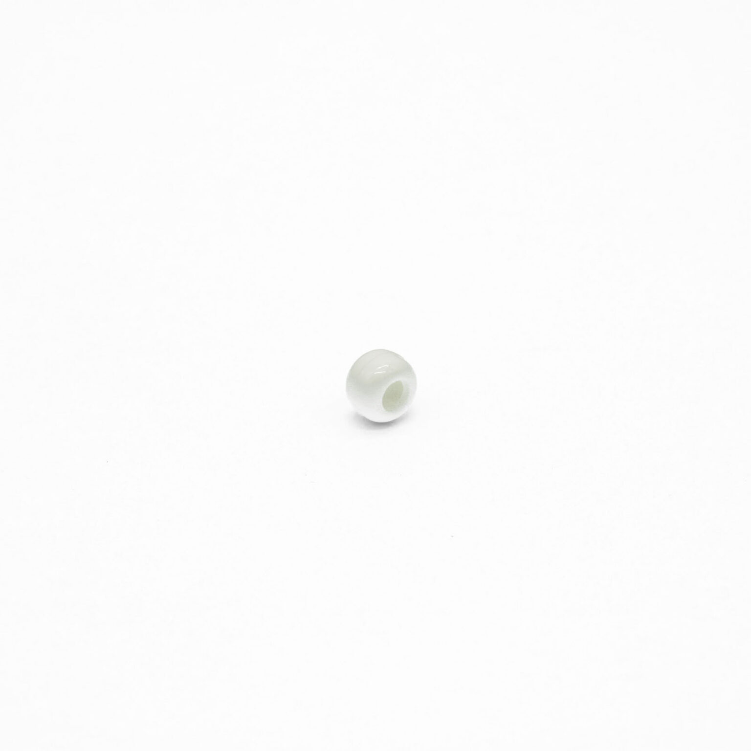This is a bead, made from plastic and White in colour.