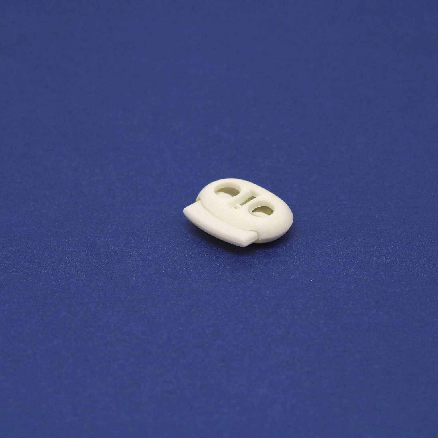 This is a 23mm toggle, made from plastic and White in colour.