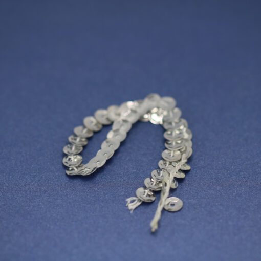 This is a drawcord, made from plastic and Silver in colour.